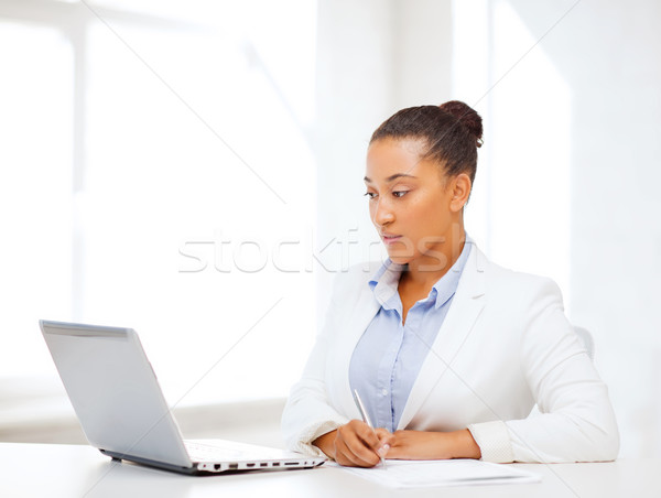 african businesswoman writing something Stock photo © dolgachov