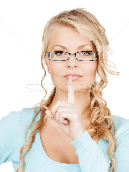 woman wearing eyeglasses with finger on her lips Stock photo © dolgachov