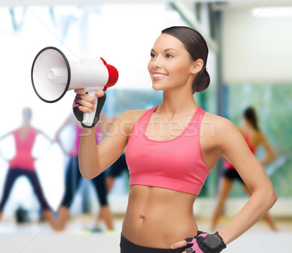Stock photo: smiling fit woman with megaphone