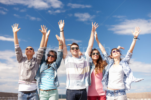 group of smiling teenagers holding hands up Stock photo © dolgachov