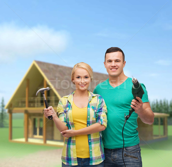 smiling couple with hammer and drill Stock photo © dolgachov