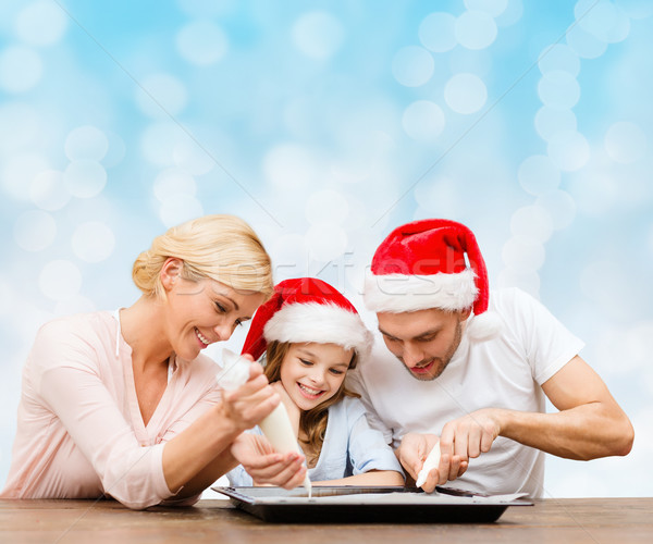 happy family in santa helper hats cooking Stock photo © dolgachov