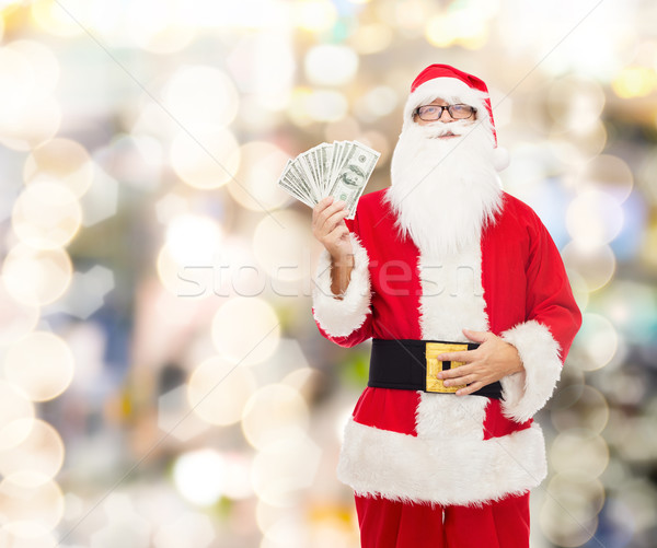 man in costume of santa claus with dollar money Stock photo © dolgachov