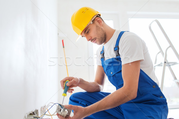 builder with tablet pc and equipment indoors Stock photo © dolgachov