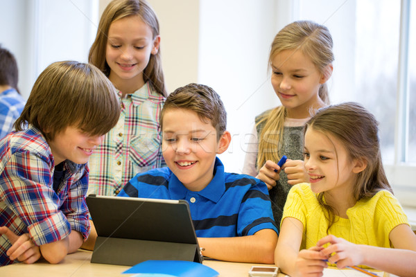 group of school kids with tablet pc in classroom Stock photo © dolgachov
