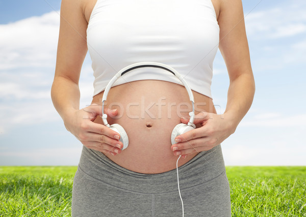 close up of pregnant woman and headphones on tummy Stock photo © dolgachov