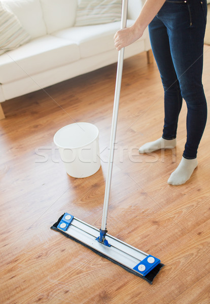 close up of woman with mop cleaning floor at home Stock photo © dolgachov