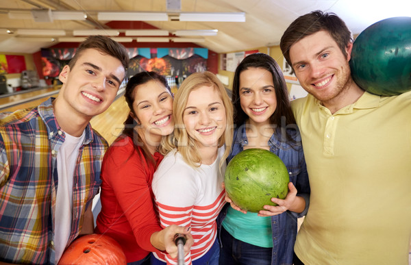 happy friends taking selfie in bowling club Stock photo © dolgachov
