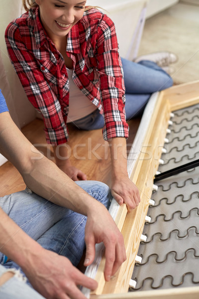 close up of couple assembling furniture at home Stock photo © dolgachov