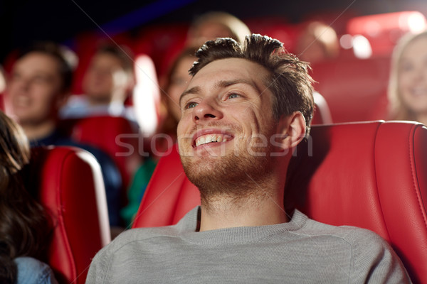 happy young man watching movie in theater Stock photo © dolgachov