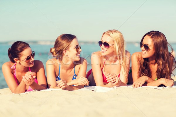 group of smiling women in sunglasses on beach Stock photo © dolgachov
