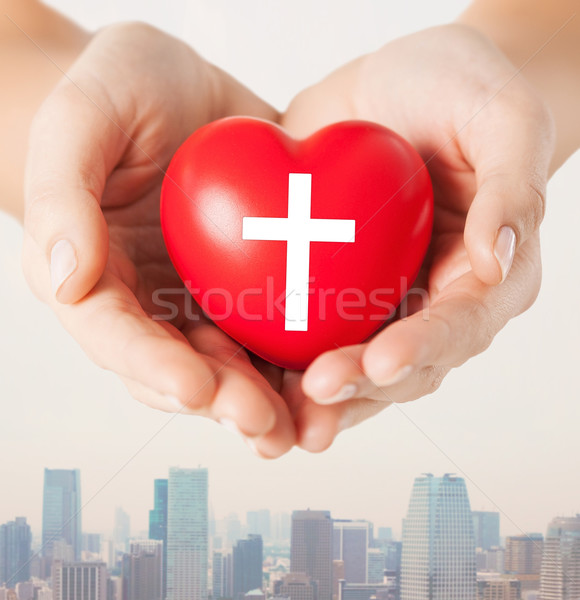 close up of hands holding heart with cross symbol Stock photo © dolgachov
