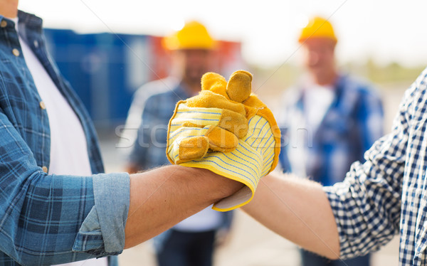 close up of builders hands making handshake Stock photo © dolgachov