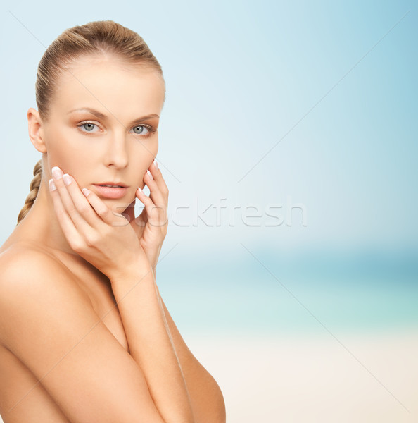 beautiful young woman touching her face Stock photo © dolgachov