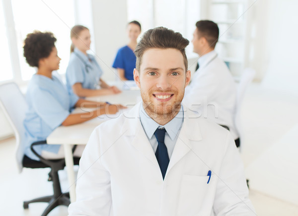 happy doctor over group of medics at hospital Stock photo © dolgachov