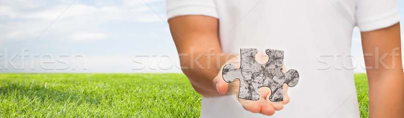 man holding puzzle over natural background Stock photo © dolgachov