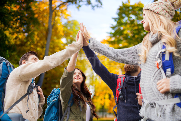 group of smiling friends with backpacks hiking Stock photo © dolgachov