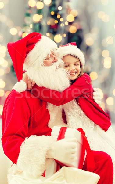 Stock photo: smiling little girl with santa claus