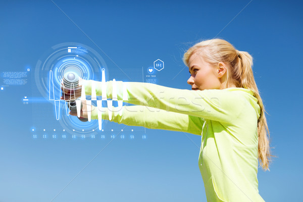 sporty woman with light dumbbells outdoors Stock photo © dolgachov