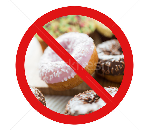 Stock photo: close up of glazed donuts pile behind no symbol