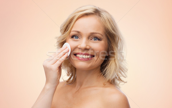 happy woman cleaning face with cotton pad Stock photo © dolgachov