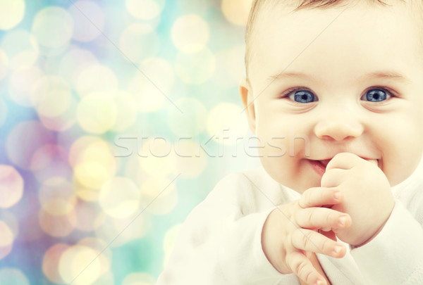happy baby over blue holidays lights background Stock photo © dolgachov