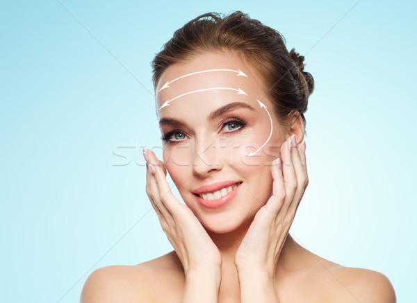 beautiful young woman touching her face Stock photo © dolgachov