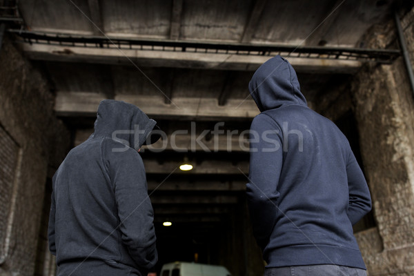 addict men or criminals in hoodies on street Stock photo © dolgachov