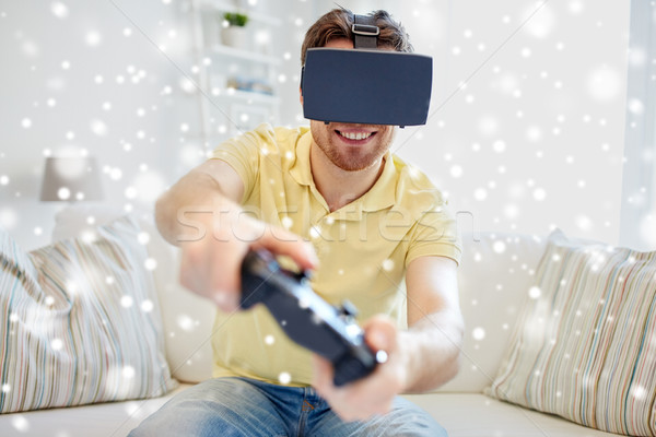 man in virtual reality headset with controller Stock photo © dolgachov