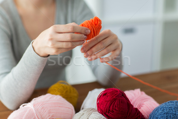 woman pulling yarn up into ball Stock photo © dolgachov