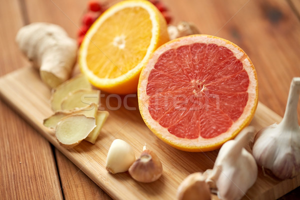 grapefruit, ginger, garlic and orange on board Stock photo © dolgachov