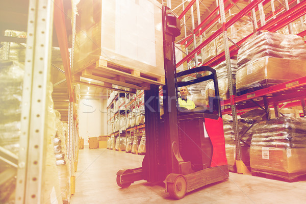 Stock photo: man on forklift loading cargo at warehouse