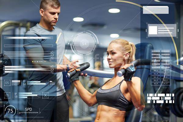 man and woman flexing muscles on gym machine Stock photo © dolgachov