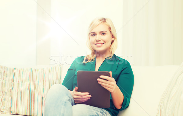 Stock photo: smiling woman with tablet pc at home