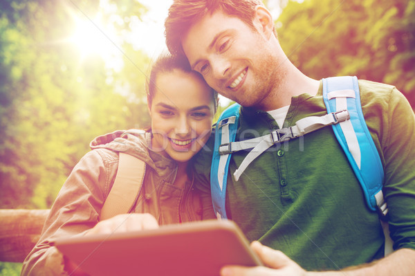 happy couple with backpacks and tablet pc outdoors Stock photo © dolgachov