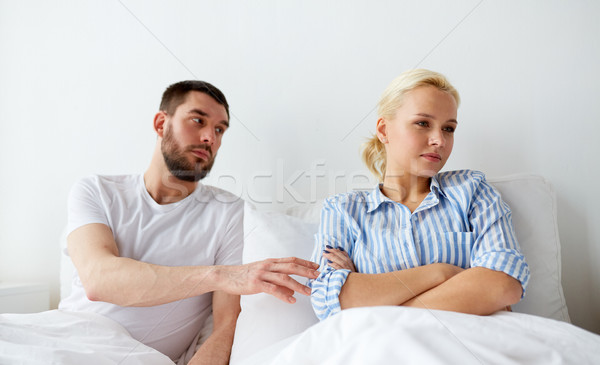 unhappy couple having conflict in bed at home Stock photo © dolgachov