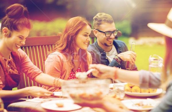 happy friends having dinner at summer garden party Stock photo © dolgachov