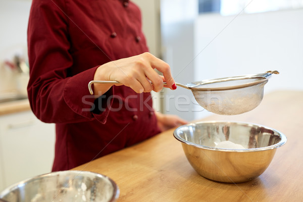 chef with flour in bowl making batter or dough Stock photo © dolgachov