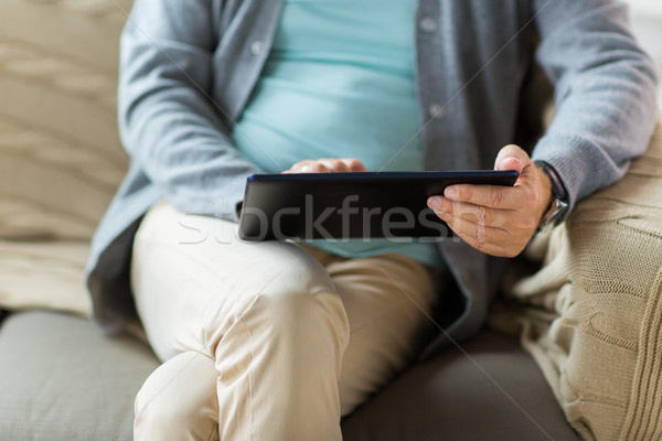 close up of senior man with tablet pc on sofa Stock photo © dolgachov