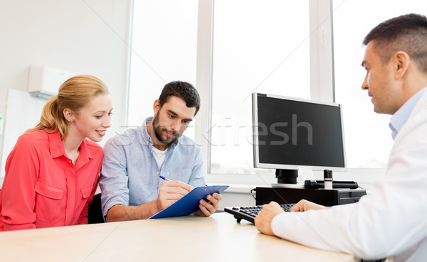 couple visiting doctor at family planning clinic Stock photo © dolgachov