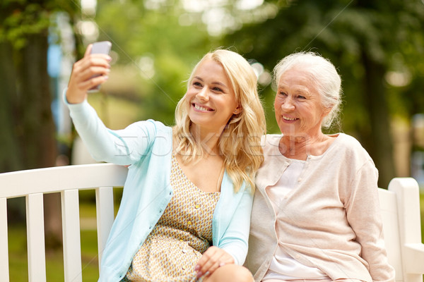 Stock photo: daughter and senior mother taking selfie at park