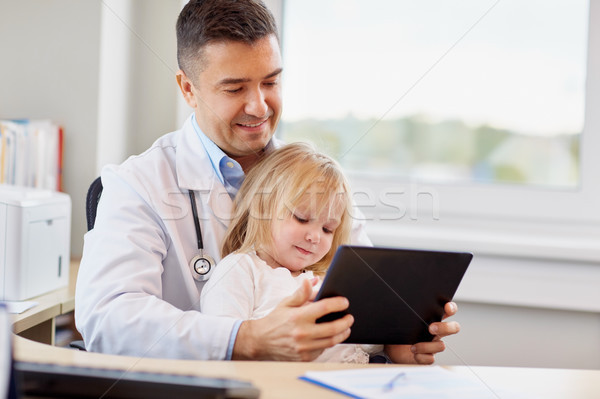 doctor and little girl with tablet pc at clinic Stock photo © dolgachov