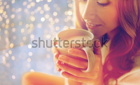 Stock photo: close up of woman with cocoa cup in bed at home