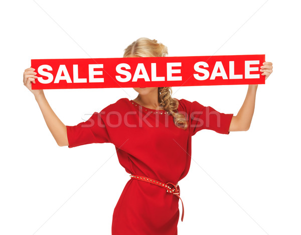 Stock photo: lovely woman in red dress with sale sign