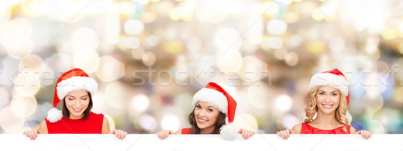 women in santa helper hat with blank white board Stock photo © dolgachov