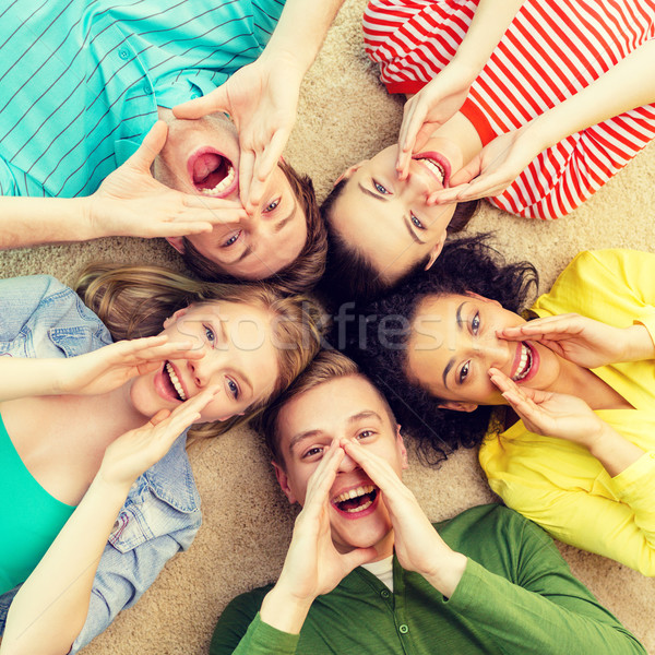 smiling people lying down on floor and screaming Stock photo © dolgachov