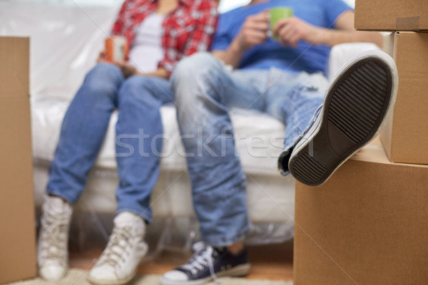 close up of couple relaxing on sofa in new home Stock photo © dolgachov