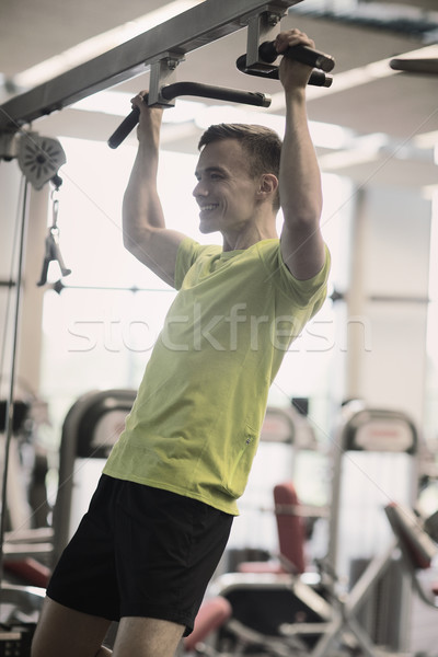 smiling man exercising in gym Stock photo © dolgachov