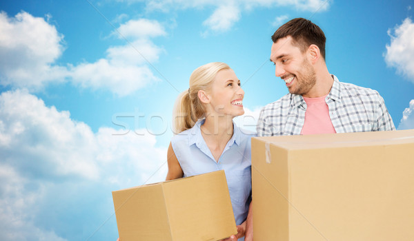 couple with cardboard boxes moving to new home Stock photo © dolgachov