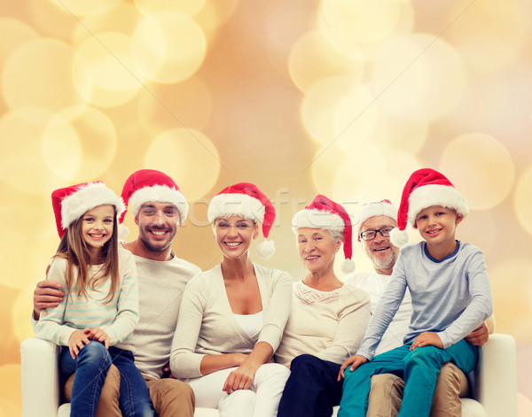 happy family in santa helper hats sitting on couch Stock photo © dolgachov
